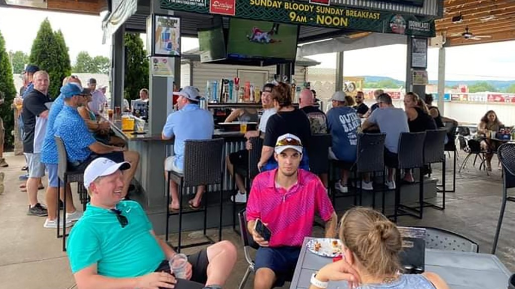 Patrons watching football on the outdoor patio